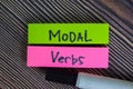 Modal Verbs write on sticky notes isolated on Wooden Table Royalty Free Stock Photo