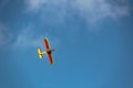 Model airplane flying in the blue sky Royalty Free Stock Photo