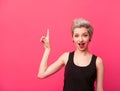 Model with blond short hair pointing up on pink Royalty Free Stock Photo