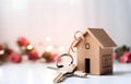 Model of cardboard house with key against bokeh background. house building, loan, real estate or buying a new home Royalty Free Stock Photo