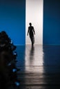 Silhouette of model on catwalk.