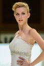 Model on catwalk wearing bridal gown