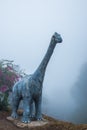 Model of Chiang Muang dinosaur with mist at Phayao province