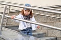 Model child girl hip hop on the stairs outdoors.children`s street fashion denim Royalty Free Stock Photo