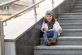 Model child hip-hop sitting on stairs outdoor Royalty Free Stock Photo