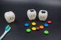 Model Cute toys teeth and colorful candy in dentistry on a black background