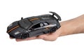 Model of a dark sports car in hand on a white background Royalty Free Stock Photo