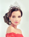 Model in a delicate make up, dressed in a red gown and crown. Royalty Free Stock Photo