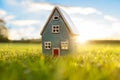 Model detatched cottage house in empty field at sunset background concept for construction and real estate Royalty Free Stock Photo