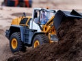 Model digging machine and trucks being demonstrated at show.