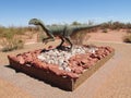 The model of a dinosaur in the sand