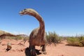 The model of a dinosaur in the sand Royalty Free Stock Photo