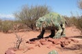 The model of a dinosaur in the sand