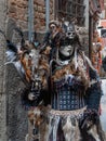 A model dressed in carnival costume of pagan witch with the sculls, furs and feathers on it in Venice, Italy