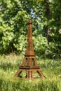 Model of the Eiffel Tower made of cardboard on green grass