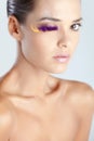 Model with fake eyelashes made of purple feather glittery lips creative makeup Royalty Free Stock Photo