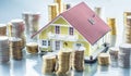 Model familly house with coins as bank or insurance concept Royalty Free Stock Photo