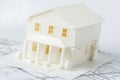 Model of the family house printed on a 3D printer with white filament by FDM technology for architectural use.