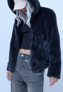 Model in fashion urban street outfit. Trendy black faux fur coat and velvet cap. Stylish Fall winter seasons