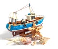 Model fishing boat with shells and starfishes on the white background Royalty Free Stock Photo