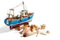 Model fishing boat with shells and starfishes on the white background Royalty Free Stock Photo
