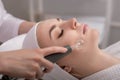 Model geting cleansing peeling rejuvenating facial treatment in a beauty SPA salon