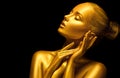 Model girl with shiny golden professional makeup over black. Beauty sexy woman with golden skin. Fashion art portrait closeup Royalty Free Stock Photo