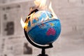 Model globe on fire. Planet Earth Burning. Global Warming and Climate Change Concept