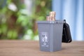 A model of a gray trash can containing recyclable trash in the garbage sorting process opens the lid and comes out with dollar coi