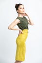 Model in green blouse, yellow suede skirt with yellow belt, isolated on white background. Royalty Free Stock Photo