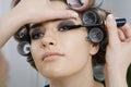 Model in Hair Curlers Having Makeup Applied Royalty Free Stock Photo