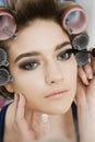 Model in Hair Curlers Having Makeup Applied Royalty Free Stock Photo