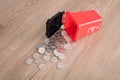 A model of hazardous trash can littered with a lot of dollar coins.The Chinese characters on the trash can mean`Harmful refuse`and