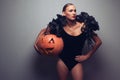 Model holding halloweens pumpkin