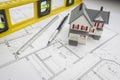 Model Home, Level, Pencil and Ruler Resting on House Plans Royalty Free Stock Photo