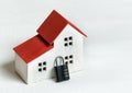 Model home and lock on white background. Home safety protection concept. Closeup Royalty Free Stock Photo