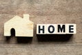 Model in home shape with letter block in word home on wood background Royalty Free Stock Photo