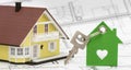 model home standing on construction plan and house key Royalty Free Stock Photo