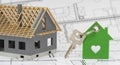 model home standing on construction plan and house key Royalty Free Stock Photo