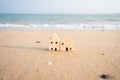 Model house on the beach, wave and sea background, real estate business ideas Royalty Free Stock Photo