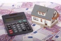 Model house, calculator and five hundred euro Royalty Free Stock Photo