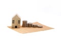 Model house and coin stack on white background mortgage