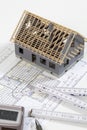 Model house folding ruler calculator hard hat pen on blueprint