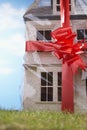 Model house gift-wrapped with red ribbon and bow close-up Royalty Free Stock Photo