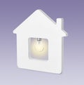 Model of house with glowing light bulb on background. Energy efficiency, loan, property or business idea concepts Royalty Free Stock Photo