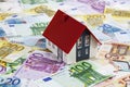 Model house on heap of euro notes Royalty Free Stock Photo