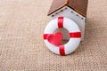 Model house and a life preserver with heart shaped Royalty Free Stock Photo