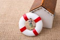 Model house and a life preserver with a woman figure Royalty Free Stock Photo