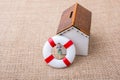 Model house and a life preserver with a woman figure Royalty Free Stock Photo