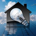 Model House with Light Bulb on Solar Panel Royalty Free Stock Photo